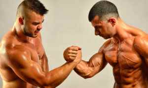 Strong bodybuilders testing their biceps in a skandemberg contest