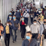 crowds of Asian people wearing face protection from infection of Corona virus or Covid -19 outbreak, pandemic,and epidemic while going to their workplace