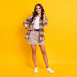 Photo of charming elegant lady toothy white smile wear plaid shirt short skirt footwear isolated yellow color background